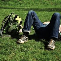 A man lying in the grassy ground