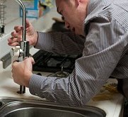 Man fixing a broken faucet