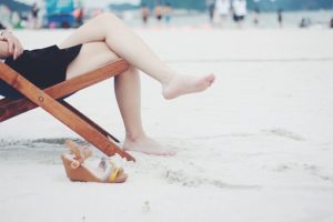 Woman on the beach sitting on her chair
